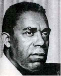 Dudley Randall, a Black man, stare off to the left of the camera