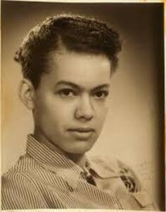 Pauli Murray, a Black woman, wears a pinstriped button down shirt and her hair parted and pulled back 