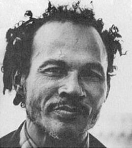 <p>An inspiration for Allen Ginsberg and other Beat writers and possibly the inventor of the term “beatnik,” Bob Kaufman (1925-1986) also influenced Amiri Baraka and the Black Arts movement. Born in New Orleans to a part-Jewish father and a black Catholic mother, Kaufman’s poetry adopted the improvisational bravado and harmonic intricacy of Bebop jazz—a debt he acknowledged when naming his only son Parker, in honor of the famous bop saxophonist. While he preferred to leave his performative verse unwritten, his poems were eventually collected in the New Directions books <em>Solitudes Crowded with Loneliness </em>(1965) and <em>The Ancient Rain: Poems 1956-1978</em> (1981). His diverse thoughts on aesthetics were assembled in the earlier prose broadsides <em>Abomunist Manifesto </em>(1959), <em>Second April </em>(1959), and <em>Does the Secret Mind Whisper? </em>(1960). Kaufman identified with the bohemian life of the proto-surrealist poet Arthur Rimbaud, and the French returned the favor by christening him “<em>Rimbaud noir</em>” and translating his poetry. Less sympathetic, the FBI first became interested in Kaufman in 1950 as a “degenerate” member of the Communist Party, and continued to shadow him through 1970.</p>